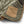 Load image into Gallery viewer, Close-up of a green quilted jacket with a brown pocket on a white background
