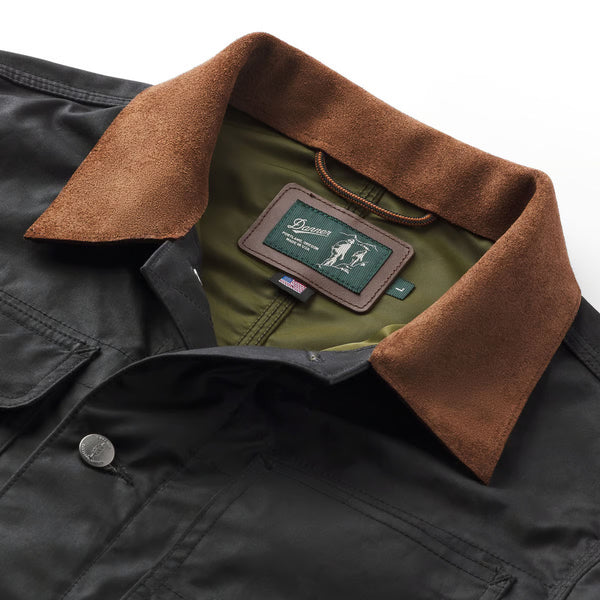 Close-up of a jacket with a brown collar and brand label on a white background