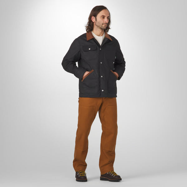Man wearing a black jacket and brown pants on a white background