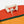 Load image into Gallery viewer, Drake's Block Stripe Knitted Rugby - Red, Yellow &amp; Purple
