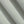 Load image into Gallery viewer, A close-up of draped light sage green knit fabric showing its fine woven texture and soft folds.
