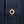 Load image into Gallery viewer, Close-up of a dark blue denim button-up shirt featuring orange contrast stitching and a silver metal button engraved with 'DUBBLEWARE'.
