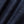 Load image into Gallery viewer, A close-up of dark indigo denim fabric with a visible twill weave and soft folds.
