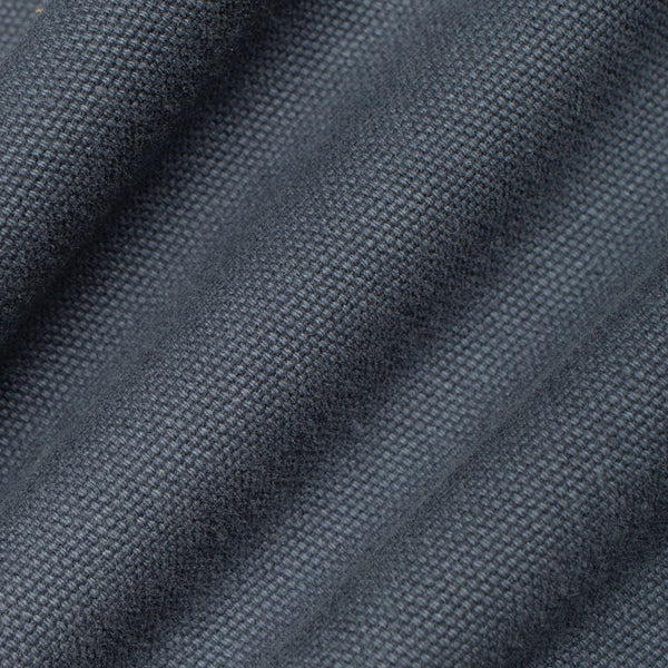 A close-up of dark slate blue-gray textured fabric with a fine woven pattern and soft diagonal folds.
