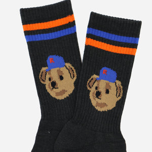 Rostersox - TEAM BEAR SOCKS - BLACK - A pair of black crew socks featuring a knitted illustration of a puppy wearing a blue cap with a red letter 'B' on the side, and two horizontal stripes near the cuff in blue and orange. - Alternative View 1