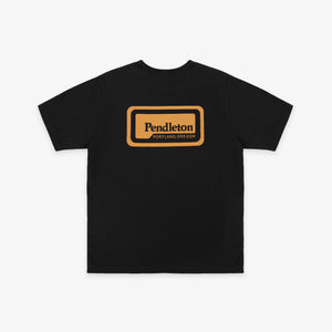 Pendleton - Pendleton Patch T-Shirt - Dark Grey - A black short-sleeve t-shirt with a tan rectangular graphic on the chest that reads 'Pendleton PORTLAND OREGON'. The t-shirt is displayed flat against a light gray background. - Alternative View 1