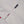 Load image into Gallery viewer, Close-up of a light gray woven fabric garment with a small navy brand tag reading PONDUTTON in gold lettering.
