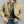 Load image into Gallery viewer, A man wearing a tan utility overshirt over a green henley shirt and blue jeans, shown from the neck down against a plain gray studio background.
