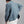 Load image into Gallery viewer, A man wearing a blue and beige plaid flannel shirt, shown from the back, paired with white pants against a plain gray background.
