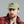 Load image into Gallery viewer, A man wearing an olive green baseball cap with a circular 'APL' eagle patch on the front, paired with a red and black plaid flannel shirt, photographed against a solid gray background.

